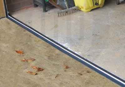 Close-up of self-adhesive and screw-fix door thresholds side by side